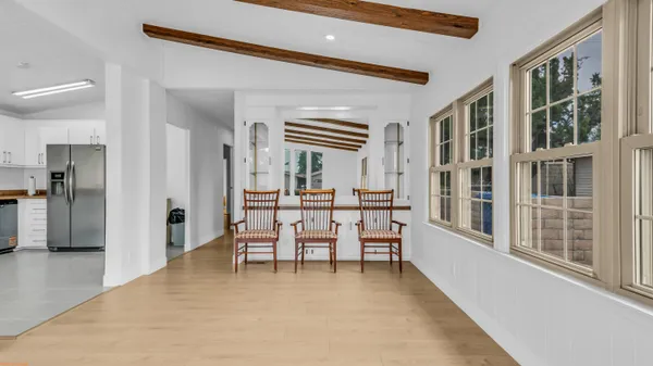 a dining room with furniture and a large window