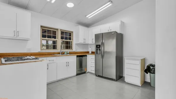 a kitchen with stainless steel appliances a refrigerator and a stove