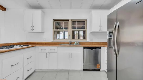a kitchen with white cabinets and a sink