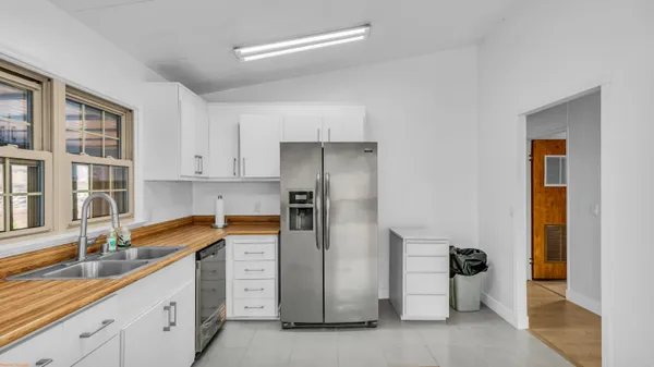 a kitchen with a sink and refrigerator