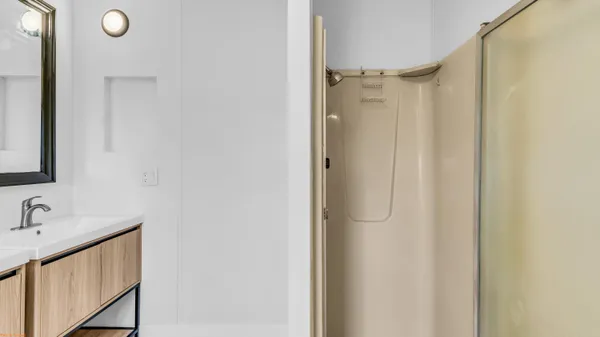 a bathroom with a shower and a sink