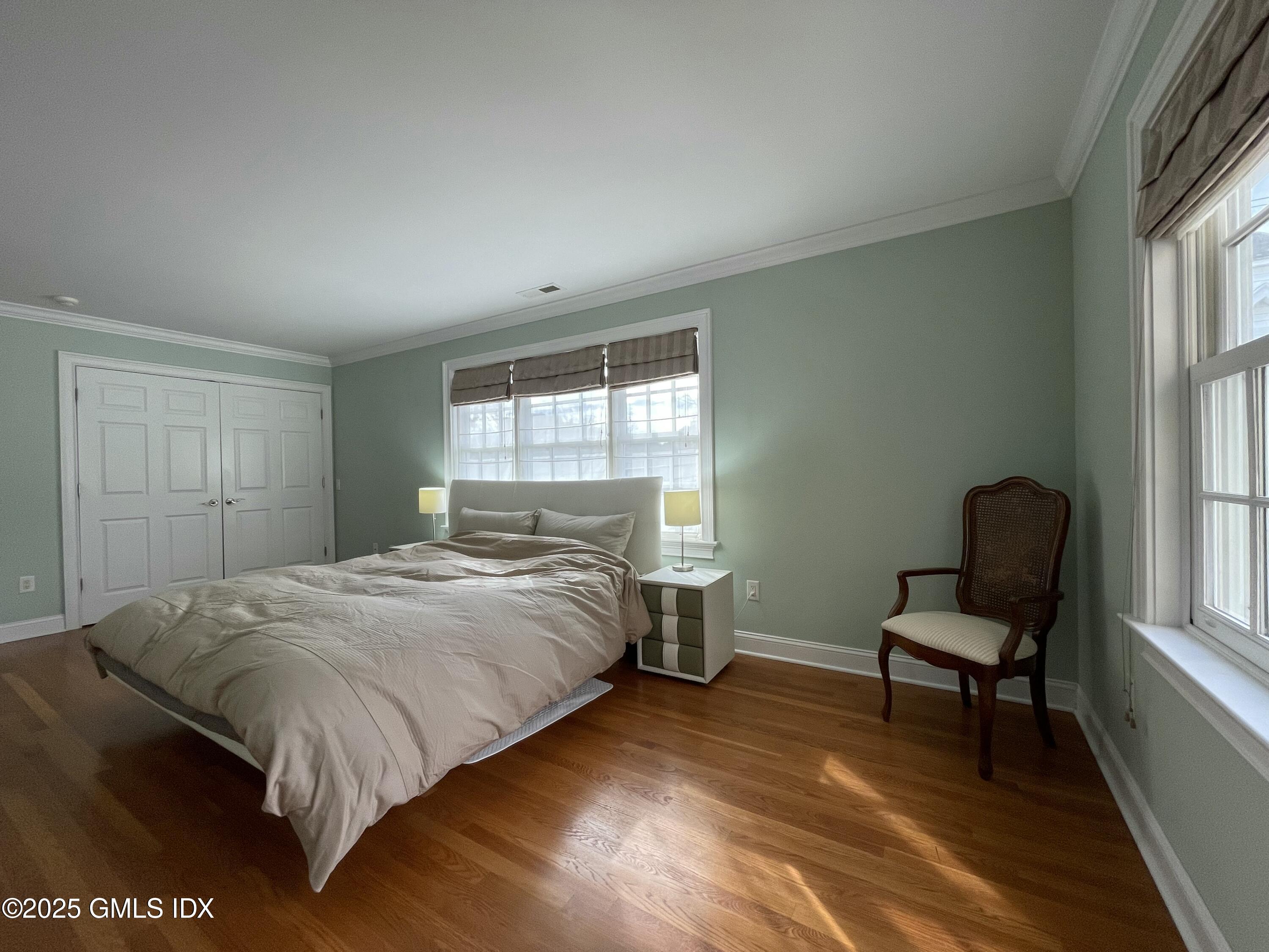1 Northfield Street, Unit B Greenwich, CT 06830 - Photo 14 of 30 a bedroom with a bed and chair