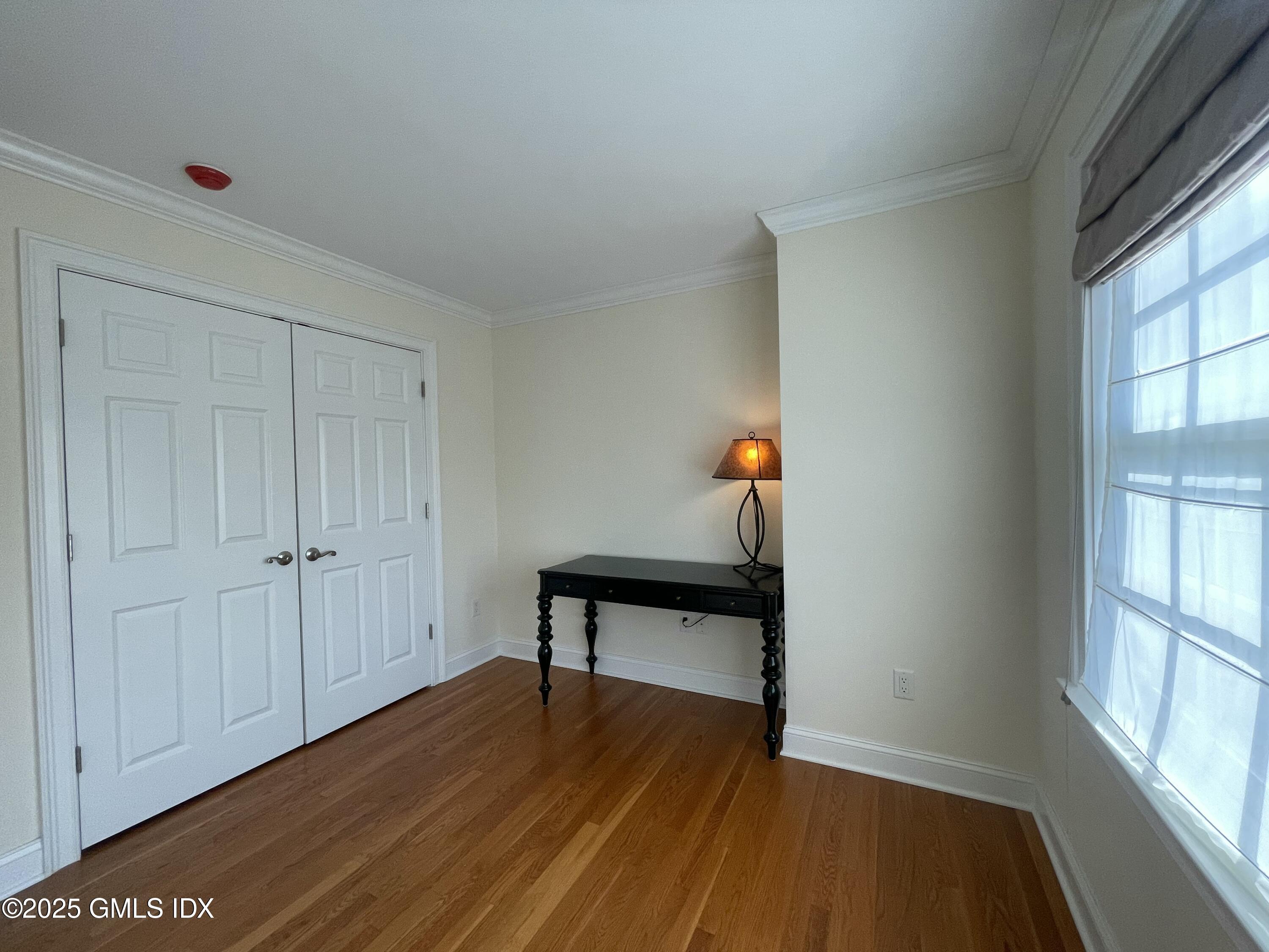1 Northfield Street, Unit B Greenwich, CT 06830 - Photo 19 of 30 a view of room with window and wooden floor