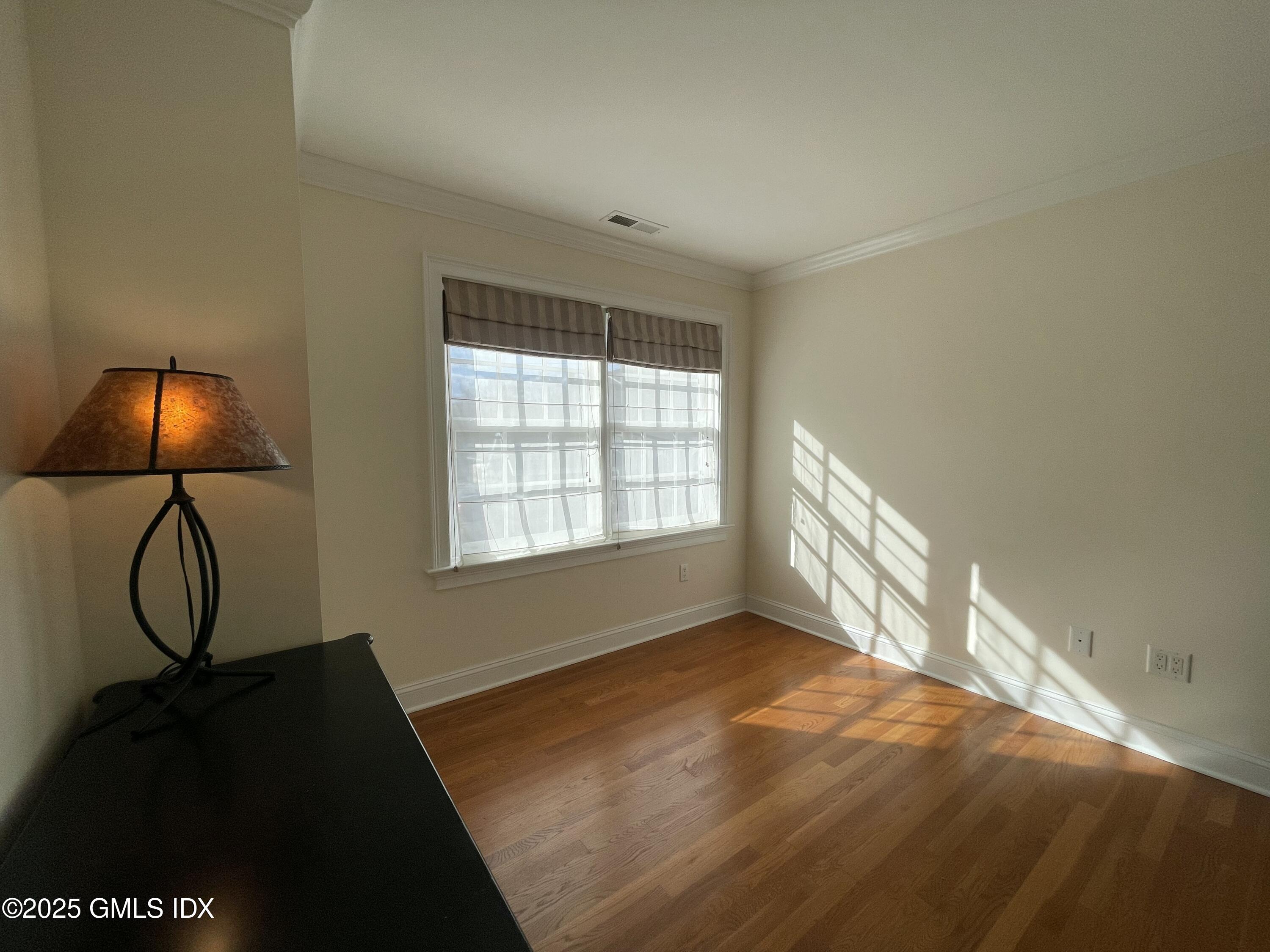 1 Northfield Street, Unit B Greenwich, CT 06830 - Photo 20 of 30 a room with a window and wooden floor