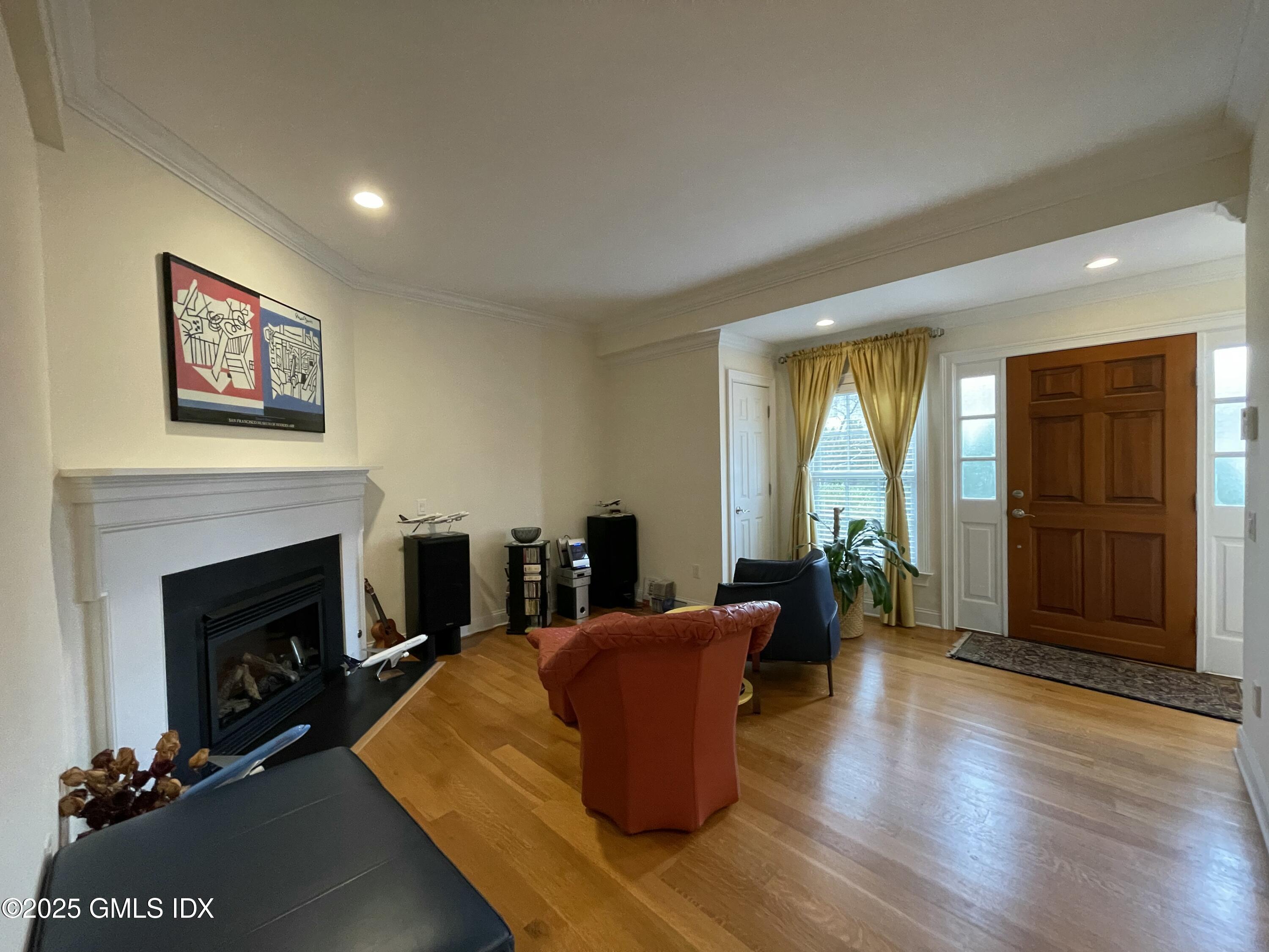 1 Northfield Street, Unit B Greenwich, CT 06830 - Photo 2 of 30 a living room with furniture wooden floor and a fireplace