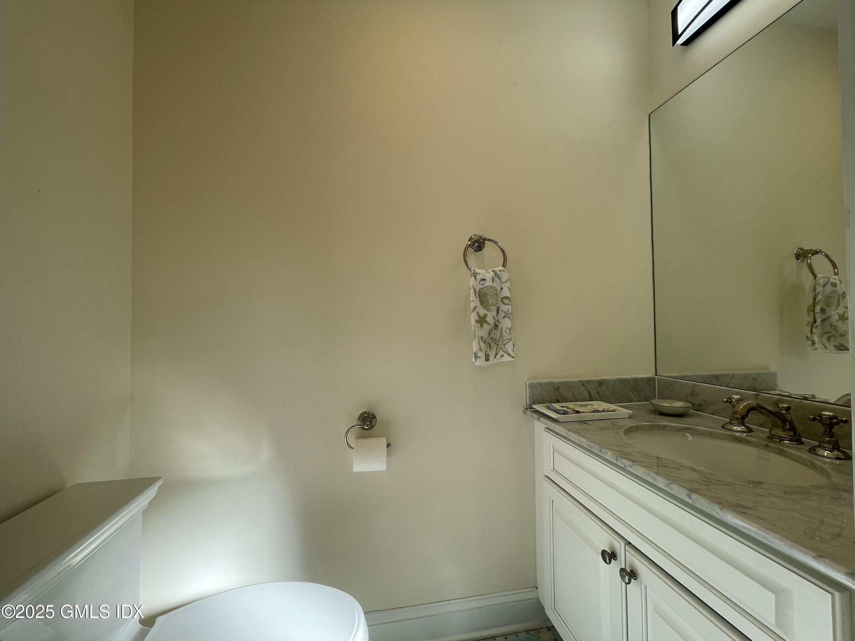 1 Northfield Street, Unit B Greenwich, CT 06830 - Photo 27 of 30 a bathroom with a granite countertop sink and a mirror