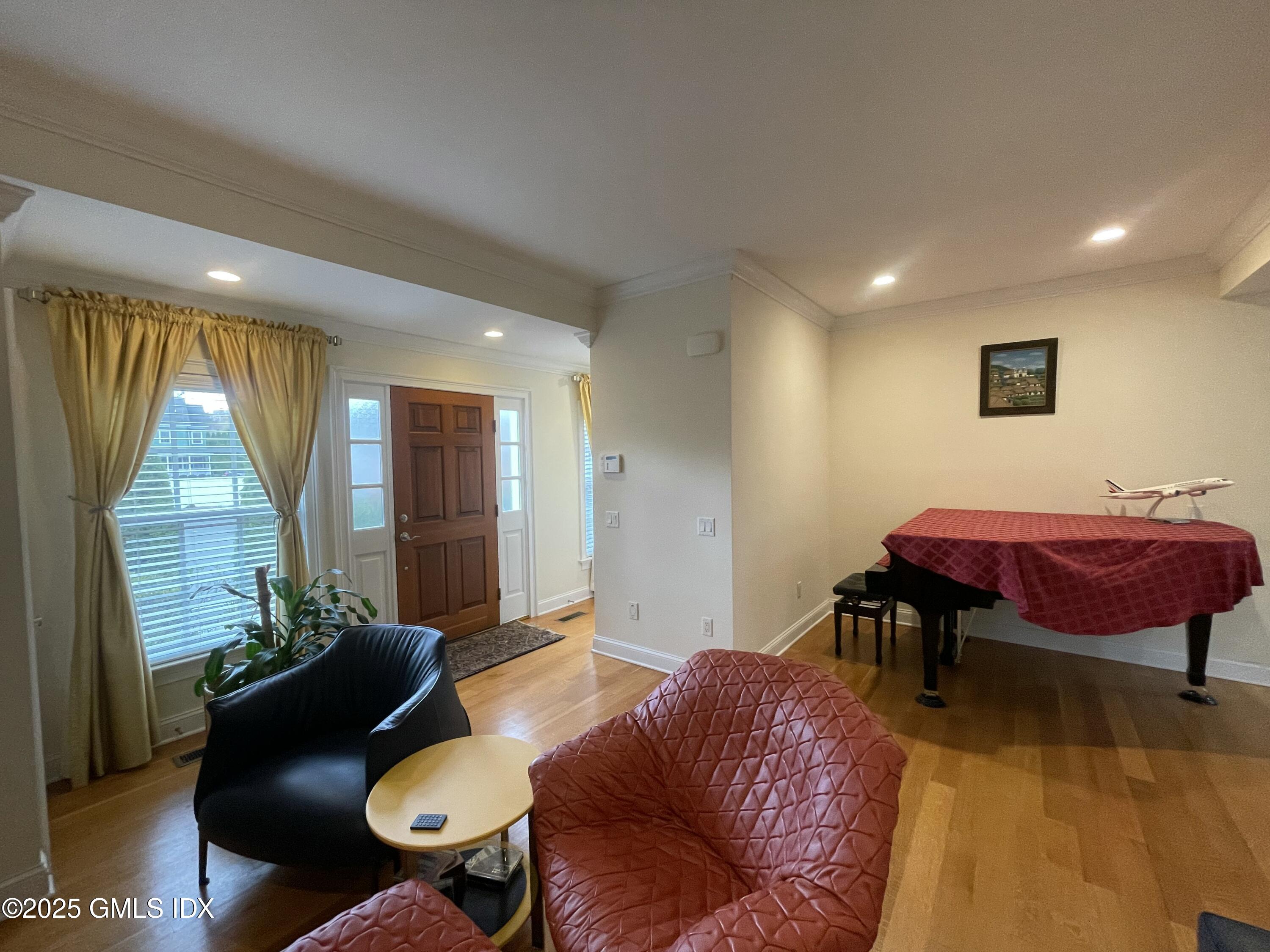 1 Northfield Street, Unit B Greenwich, CT 06830 - Photo 3 of 30 a living room with furniture a rug and a large window