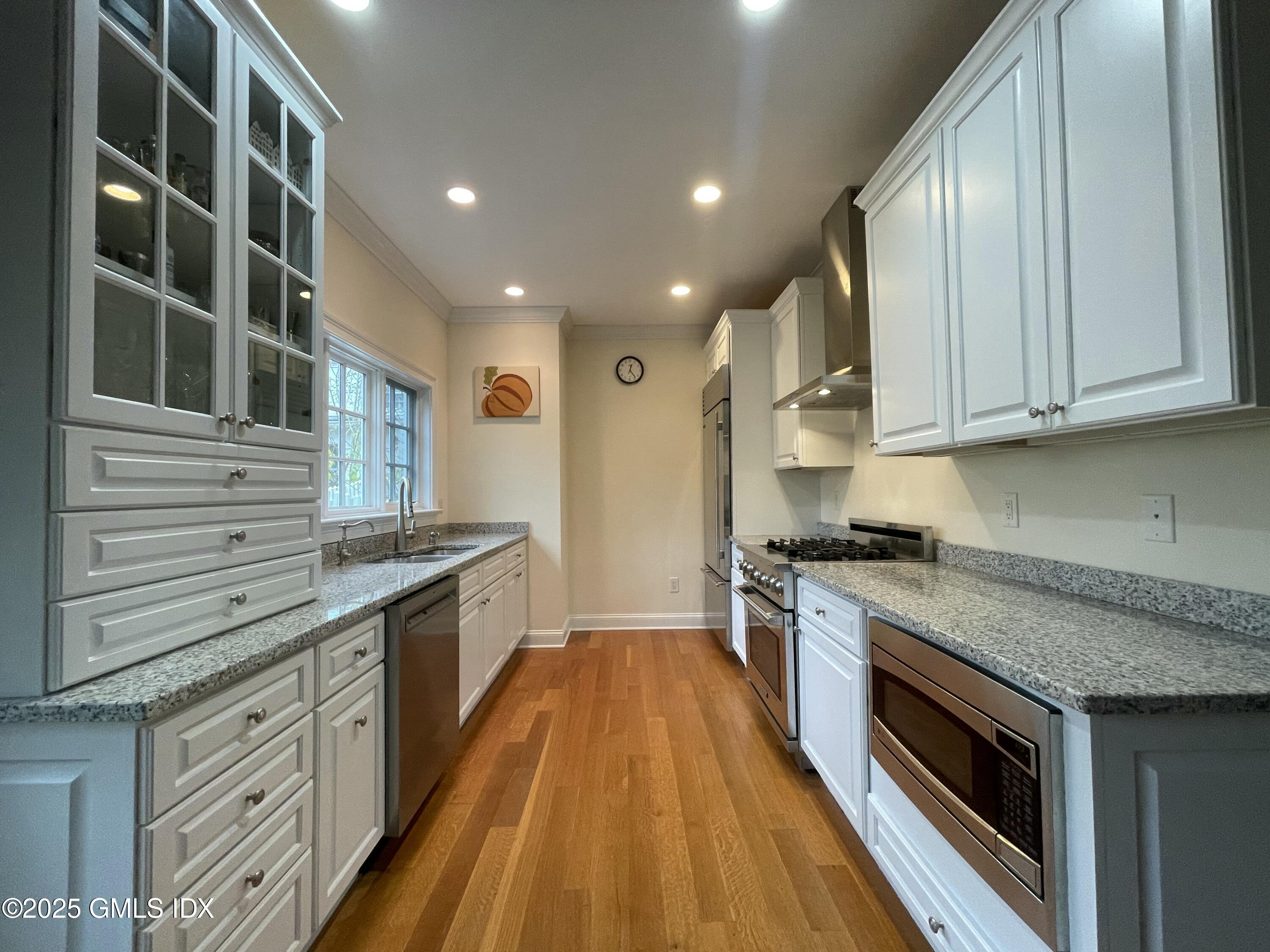 1 Northfield Street, Unit B Greenwich, CT 06830 - Photo 5 of 30 a large kitchen with granite countertop a stove and a sink