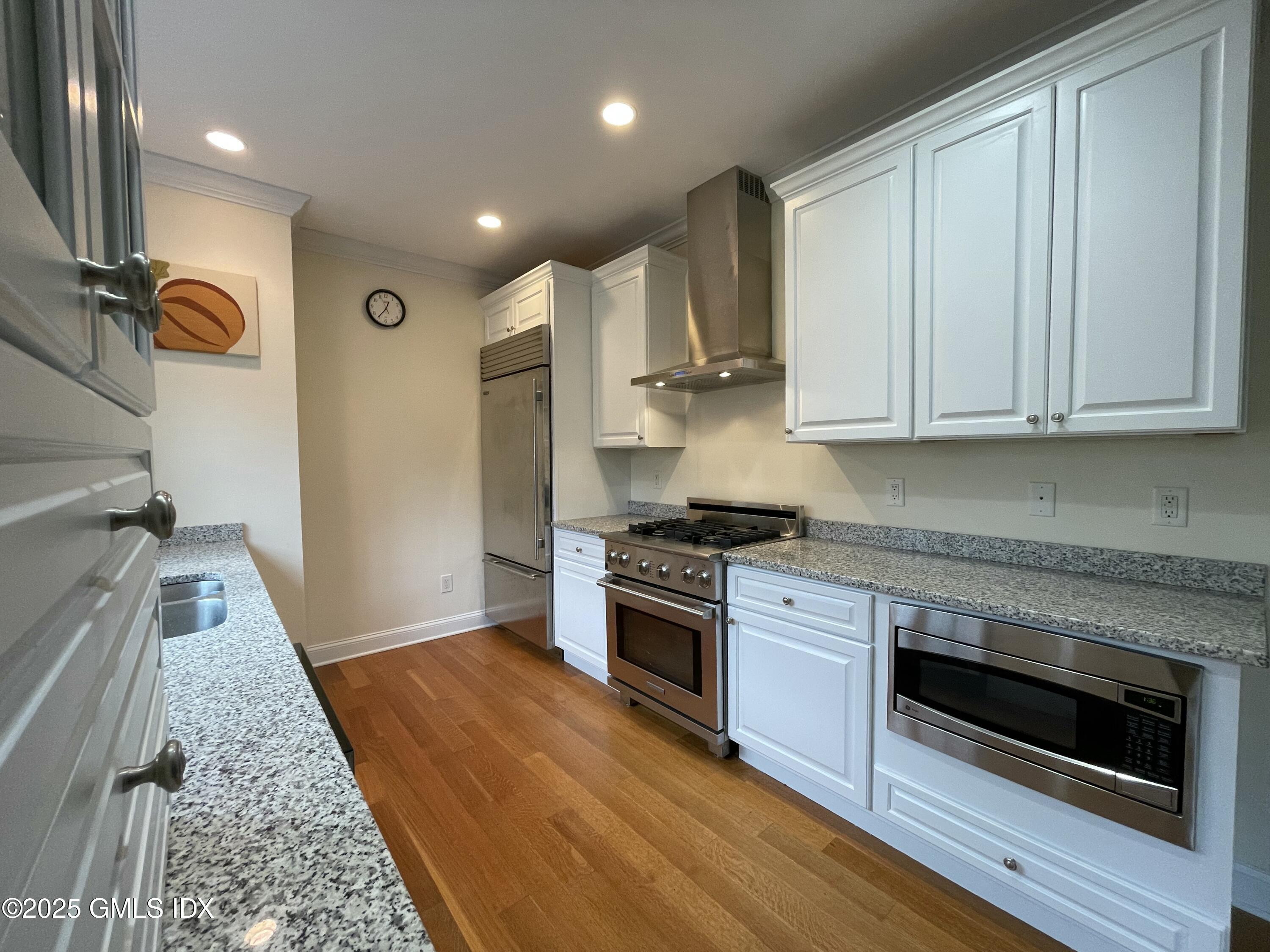 1 Northfield Street, Unit B Greenwich, CT 06830 - Photo 6 of 30 a kitchen with stainless steel appliances granite countertop a stove and a refrigerator