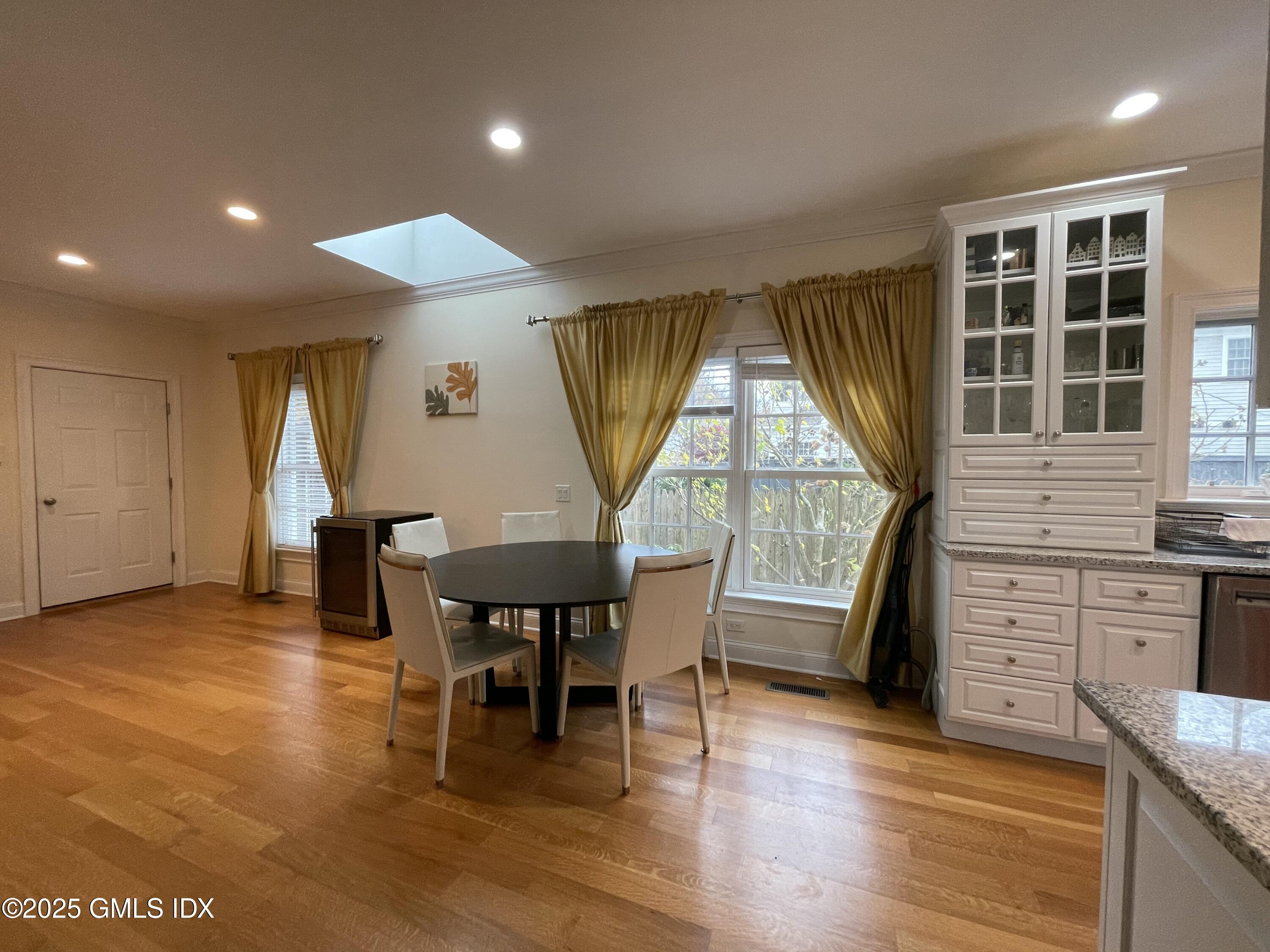 1 Northfield Street, Unit B Greenwich, CT 06830 - Photo 8 of 30 a view of a dining room with furniture window and wooden floor