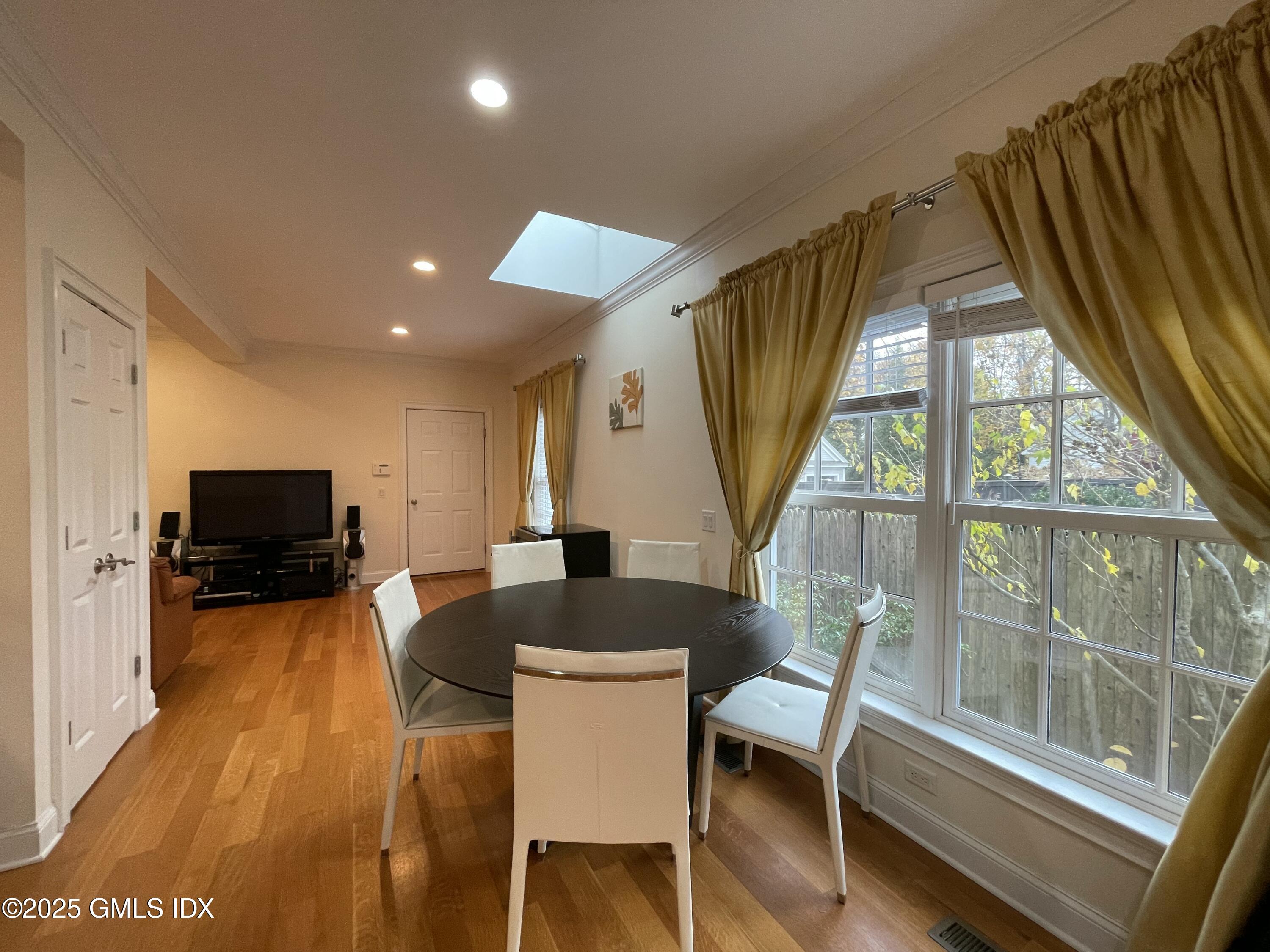 1 Northfield Street, Unit B Greenwich, CT 06830 - Photo 9 of 30 a view of a dining room with furniture a livingroom and wooden floor