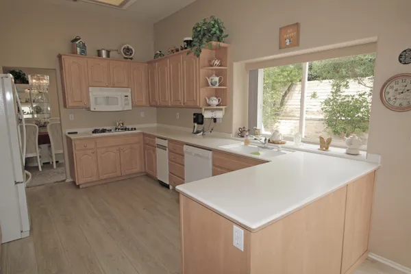 a kitchen with stainless steel appliances a sink a stove and a refrigerator