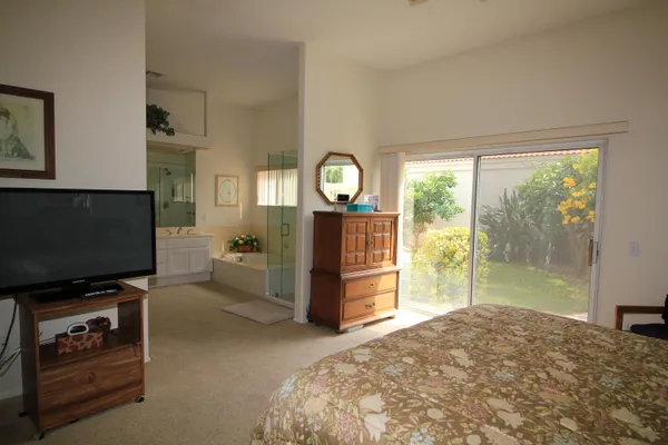 a bedroom with furniture and a flat screen tv