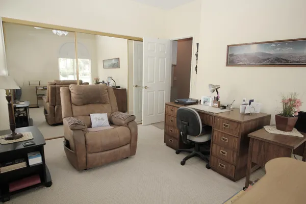 a living room with furniture and a lamp