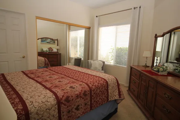 a bedroom with a bed and a dresser in it