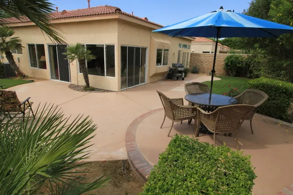 a patio table and chairs under an umbrella