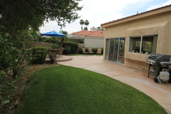 a view of a house with sitting area and garden