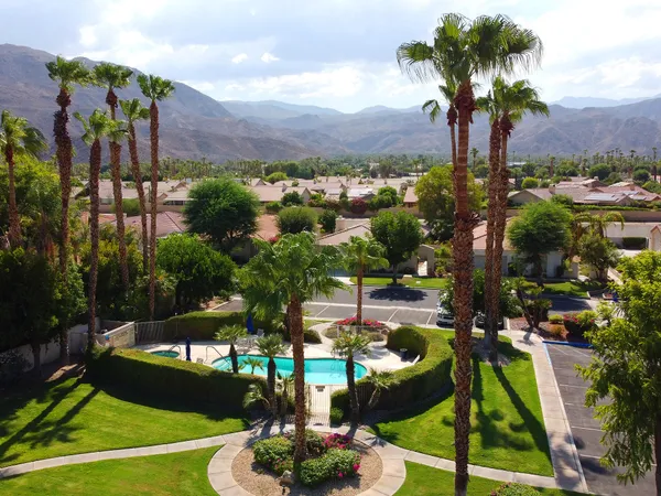 a view of a swimming pool with a patio and a garden