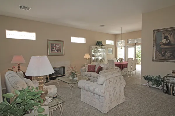a living room with furniture and a lamp