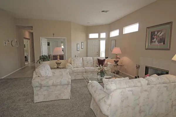 a living room with furniture and large mirror