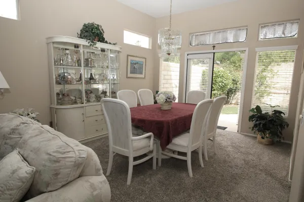 a view of a dining room with furniture window and outside view