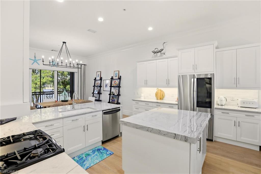 9263 Museo Circle, Unit 202 Naples, FL 34114 - Photo 11 of 50 a kitchen with a sink stove and refrigerator