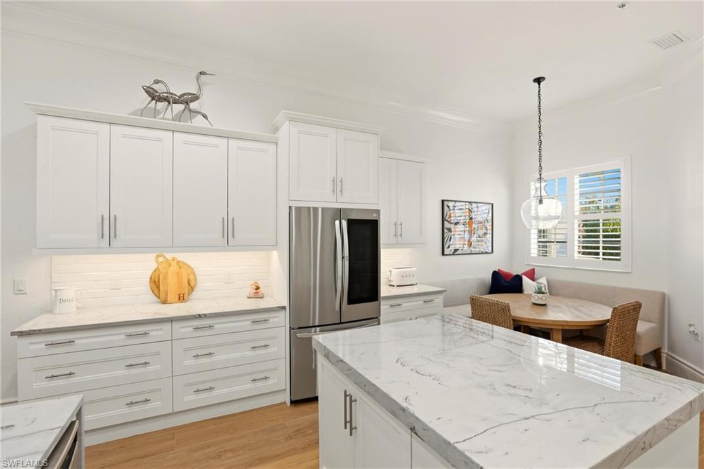 9263 Museo Circle, Unit 202 Naples, FL 34114 - Photo 16 of 50 a kitchen with granite countertop a stove a sink and a refrigerator