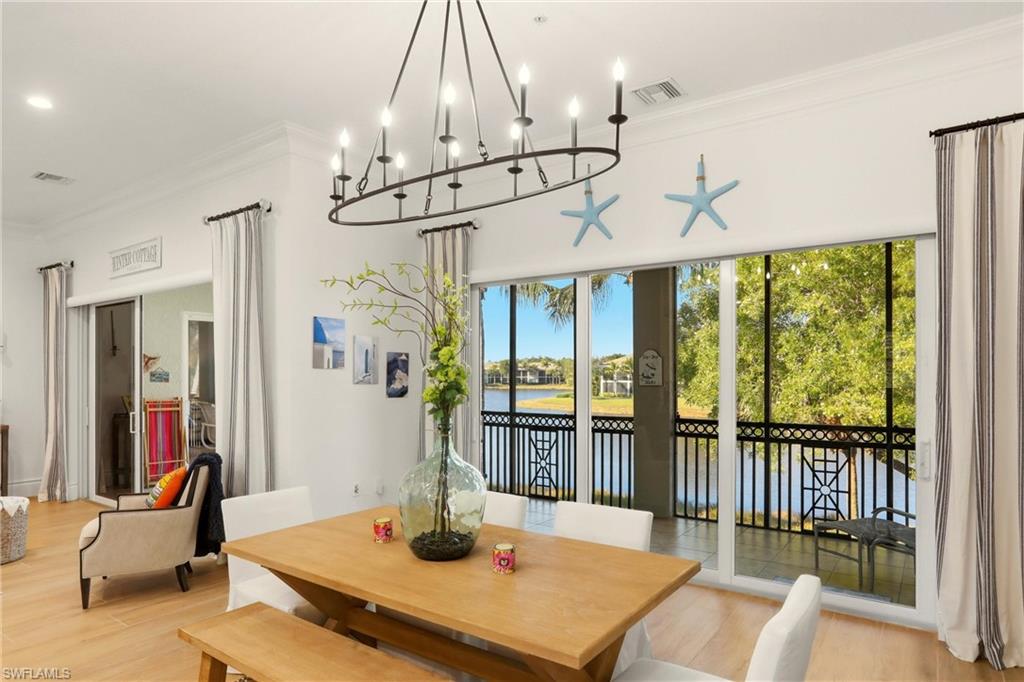 9263 Museo Circle, Unit 202 Naples, FL 34114 - Photo 18 of 50 a dining room with wooden floor and windows