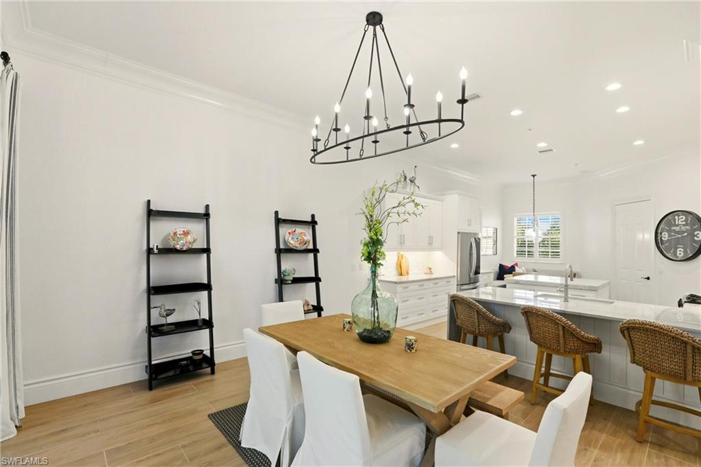 9263 Museo Circle, Unit 202 Naples, FL 34114 - Photo 20 of 50 a view of a dining room with furniture and wooden floor