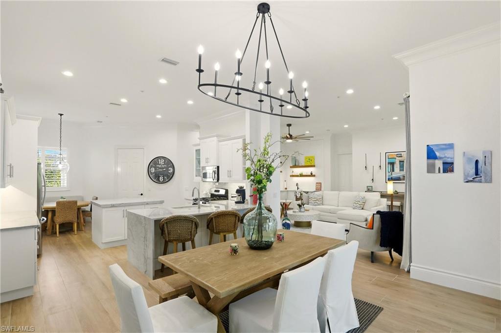 9263 Museo Circle, Unit 202 Naples, FL 34114 - Photo 21 of 50 a living room with fireplace furniture and a wooden floor