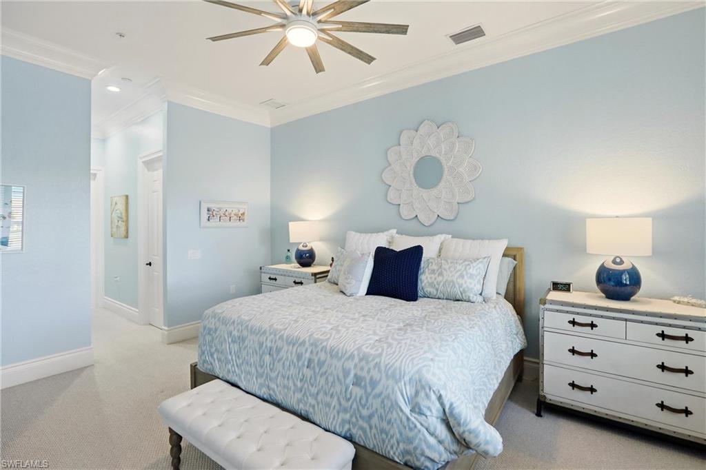 9263 Museo Circle, Unit 202 Naples, FL 34114 - Photo 26 of 50 a bedroom with a bed and a chandelier