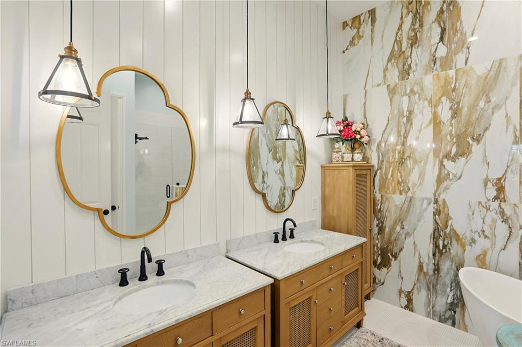 9263 Museo Circle, Unit 202 Naples, FL 34114 - Photo 28 of 50 a bathroom with a sink and a mirror