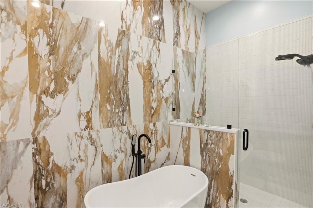 9263 Museo Circle, Unit 202 Naples, FL 34114 - Photo 29 of 50 a white toilet sitting next to a shower curtain