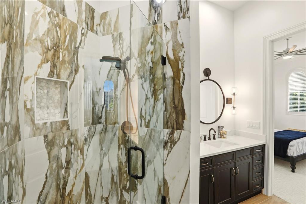 9263 Museo Circle, Unit 202 Naples, FL 34114 - Photo 34 of 50 a bathroom with a double vanity sink mirror and shower