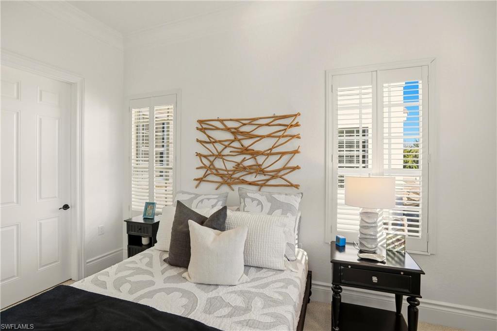 9263 Museo Circle, Unit 202 Naples, FL 34114 - Photo 38 of 50 a bedroom with a bed and a window