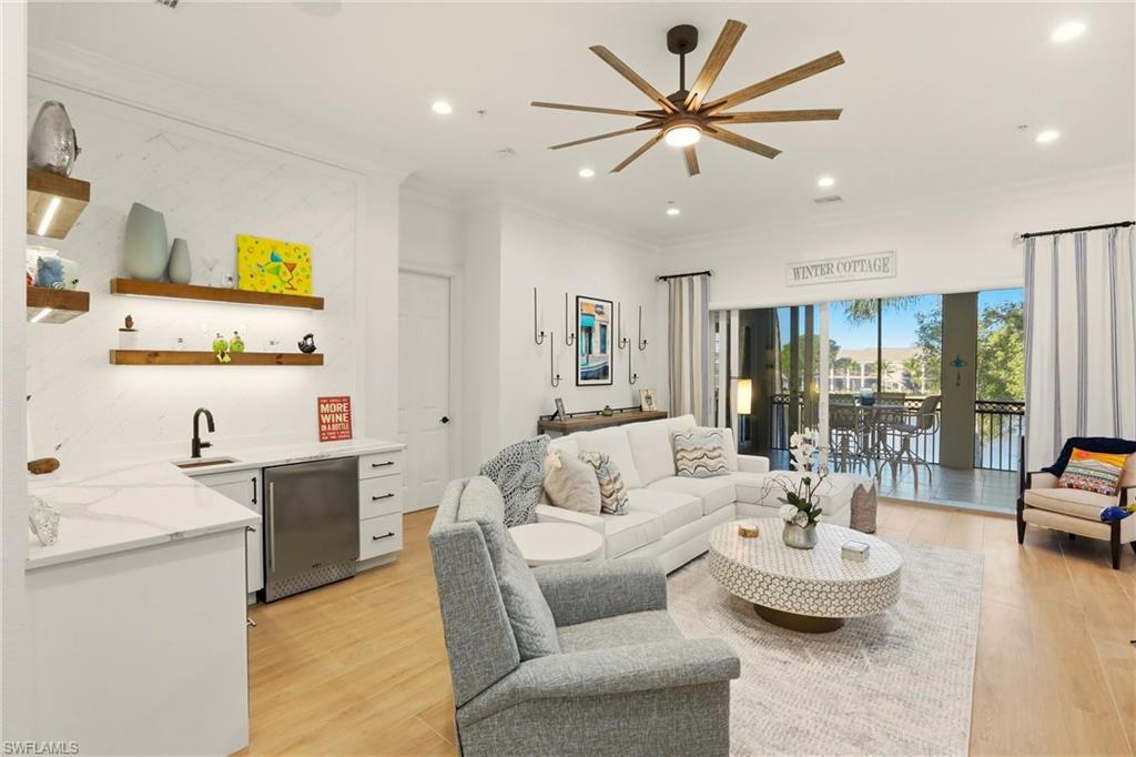 9263 Museo Circle, Unit 202 Naples, FL 34114 - Photo 7 of 50 a living room with furniture and a large window with garden view