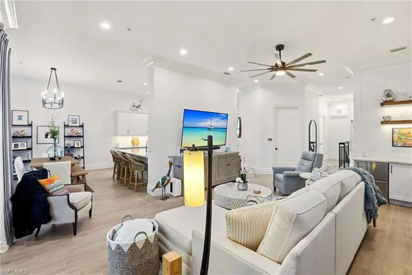 a living room with furniture a rug and a chandelier