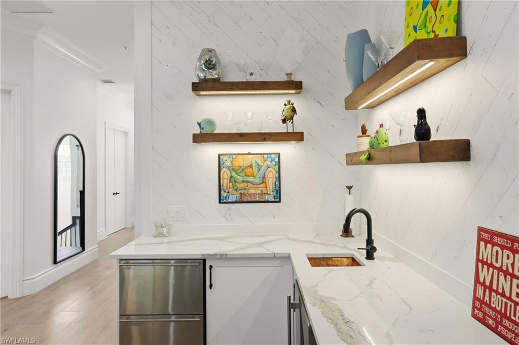 9263 Museo Circle, Unit 202 Naples, FL 34114 - Photo 9 of 50 a bathroom with a sink and mirror with bathtub