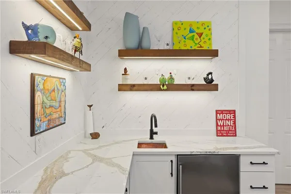 a kitchen with a sink stove and refrigerator