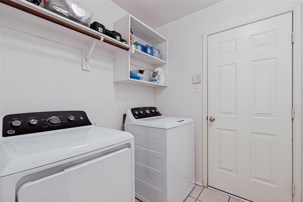 4305 Ridgewood Road Melissa, TX 75454 - Photo 20 of 26 Dedicated laundry area featuring white tile flooring and a paneled door