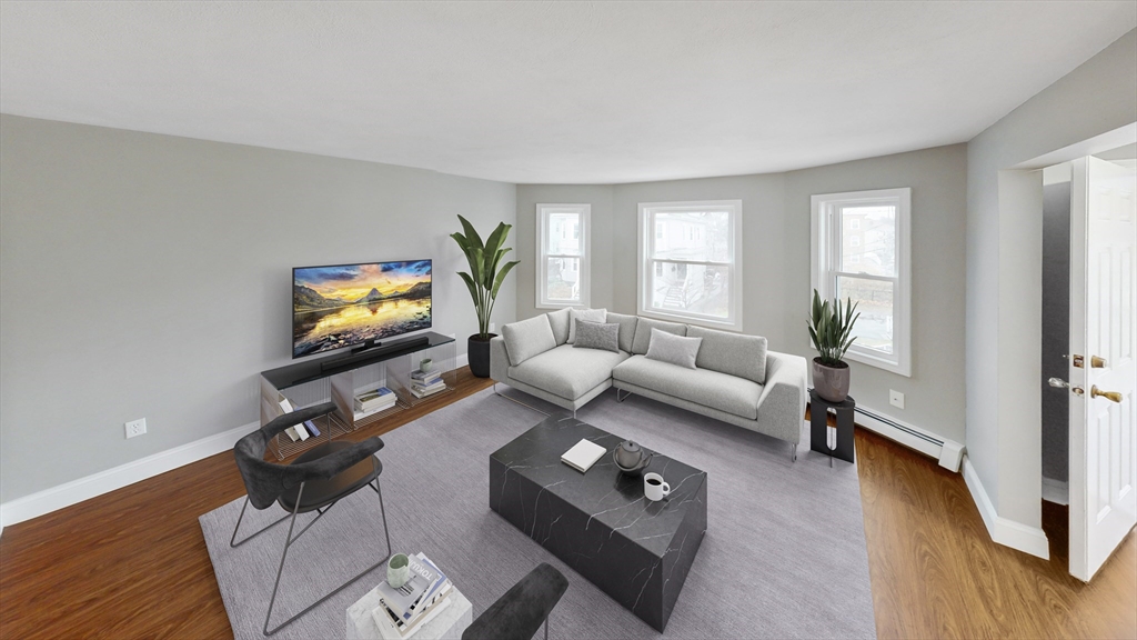 49 Rosedale Street, Unit 2 Boston, MA 02124 - Photo 2 of 9 a living room with furniture and a flat screen tv
