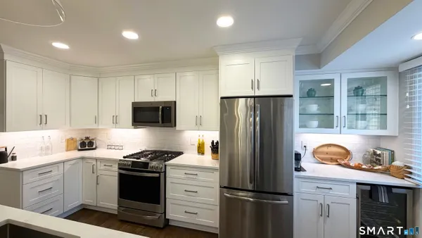 a kitchen with a refrigerator stove and sink