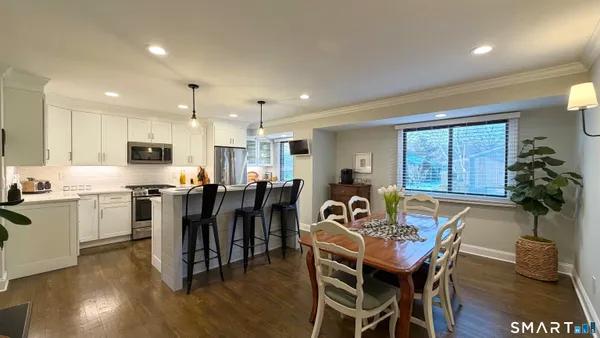 a view of a dining room with furniture window and wooden floor