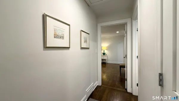 a view of a hallway with wooden floor