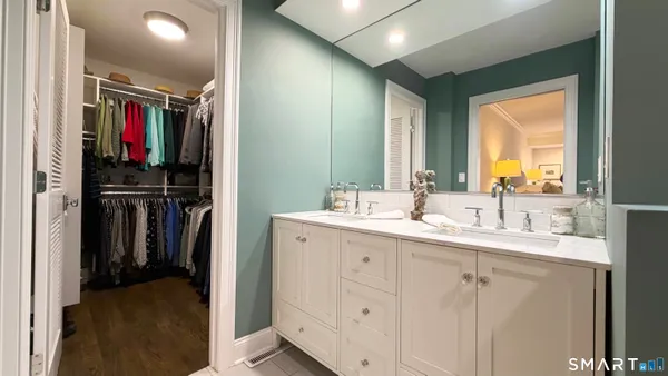 a bathroom with a double vanity sink and a mirror