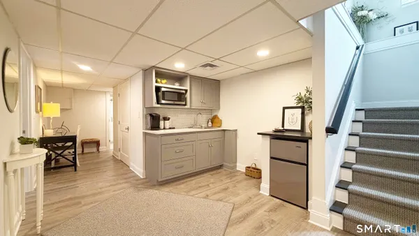 a kitchen with sink cabinets and flat screen tv