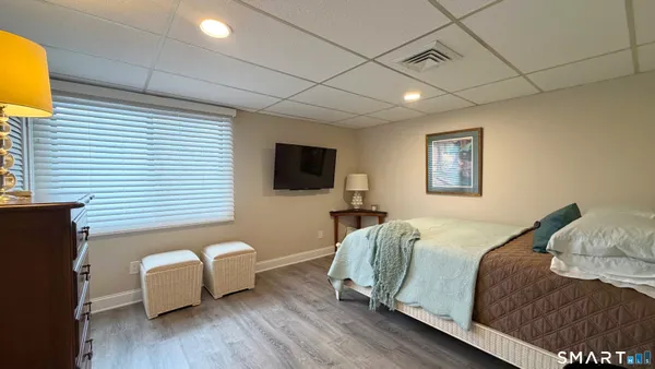 a spacious bedroom with a bed and a couch