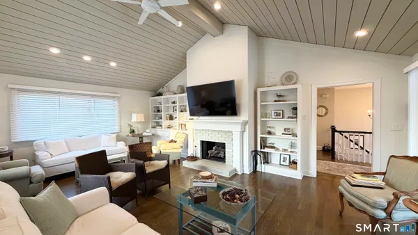 a living room with furniture fireplace and a flat screen tv