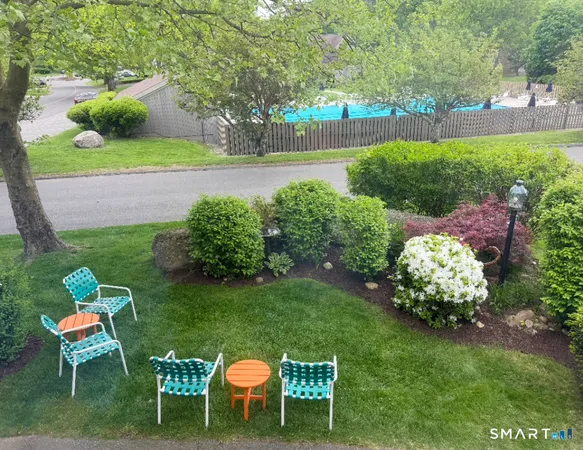 a view of a chair and table in the garden