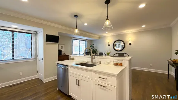 a view of a kitchen counter space a sink and appliances